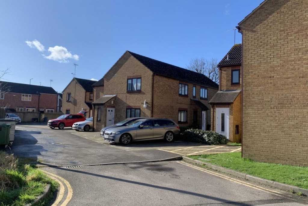 Cars parked on driveways in Swindon on a sunny day.